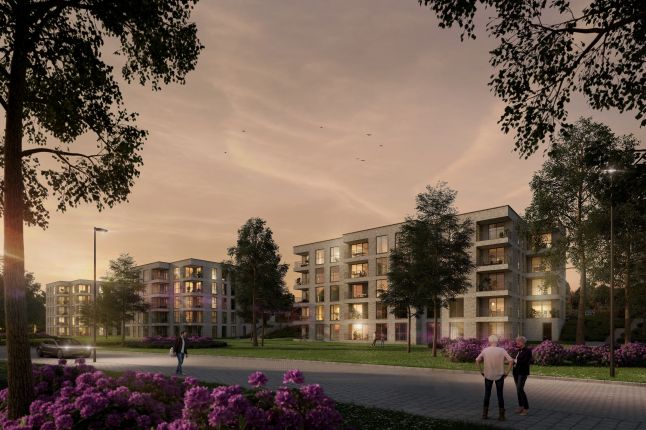 Impressie van het nieuwbouwproject De Jonkvrouw in Geldrop, met warme avondzon die de gevel van het appartementencomplex verlicht.