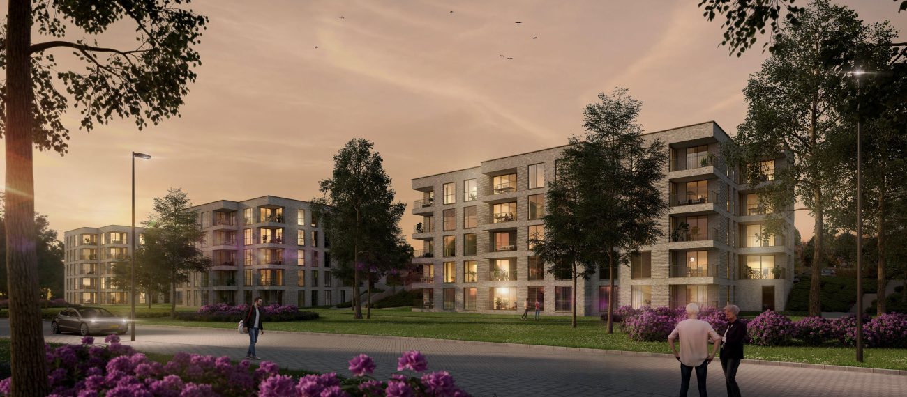 Impressie van moderne appartementencomplexen omringd door groen en bloeiende struiken tijdens zonsondergang, met wandelende mensen op de voorgrond.