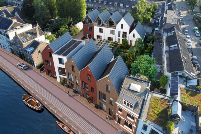 Impressie Stadsgeluk Utrecht – nieuwbouw rijwoningen aan de gracht met variërende baksteengevels, zadeldaken, zonnepanelen en groene binnentuin.