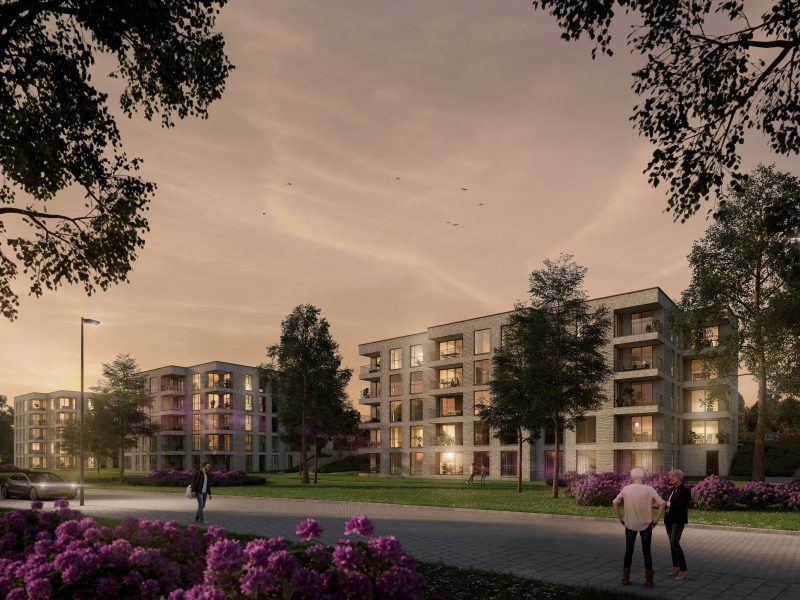 Impressie van het nieuwbouwproject De Jonkvrouw in Geldrop, met warme avondzon die de gevel van het appartementencomplex verlicht.