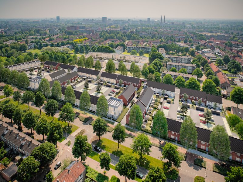 Vogelvlucht: stadswijk met rijtjeshuizen, binnenterreinen met parkeren en zonnepanelen — Ontwikkeling De Vijf van Vorst Eindhoven